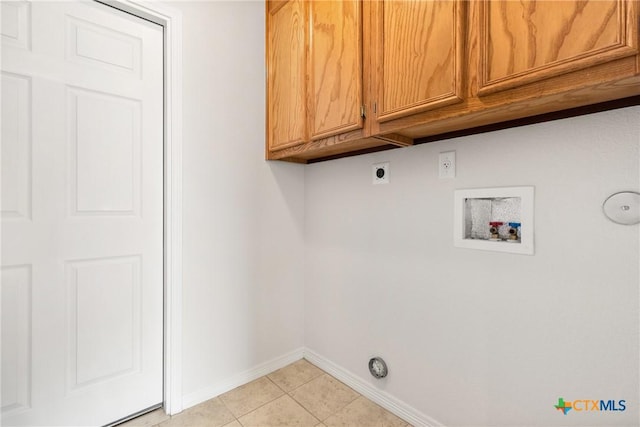 laundry area with cabinets, hookup for an electric dryer, hookup for a washing machine, and light tile patterned floors