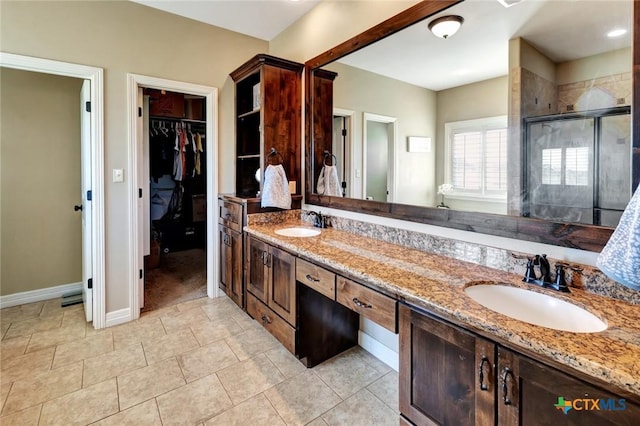 135 Wellspring Blvd, Victoria, TX 77904 - full bath featuring a shower stall, a spacious closet, double vanity, baseboards, and tile patterned flooring