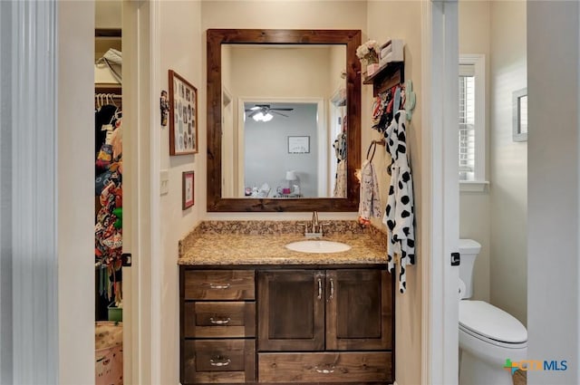135 Wellspring Blvd, Victoria, TX 77904 - bathroom with vanity, toilet, and ceiling fan