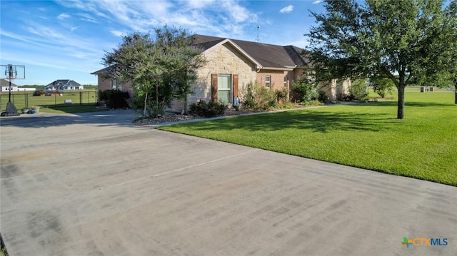 135 Wellspring Blvd, Victoria, TX 77904 - view of front of house with stone siding and a front yard