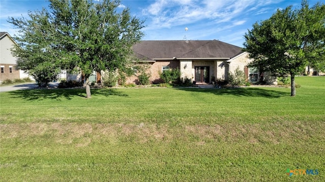 135 Wellspring Blvd, Victoria, TX 77904 - view of front facade with french doors and a front lawn