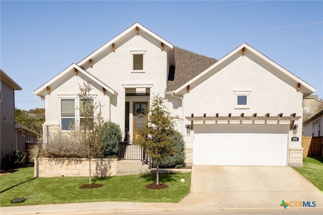 view of front of house with concrete driveway, a front lawn, and a shingled roof