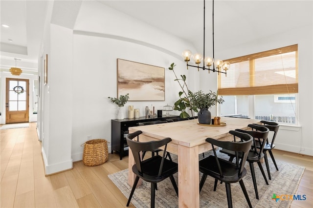 dining area featuring a healthy amount of sunlight, baseboards, and light wood-style floors