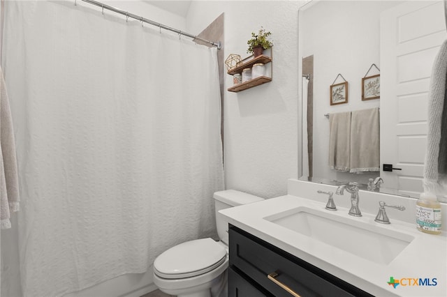 bathroom featuring toilet and vanity