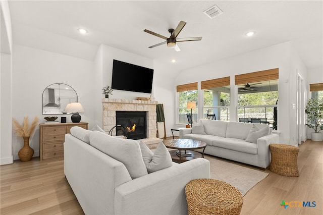 living area featuring light wood finished floors, visible vents, and a wealth of natural light