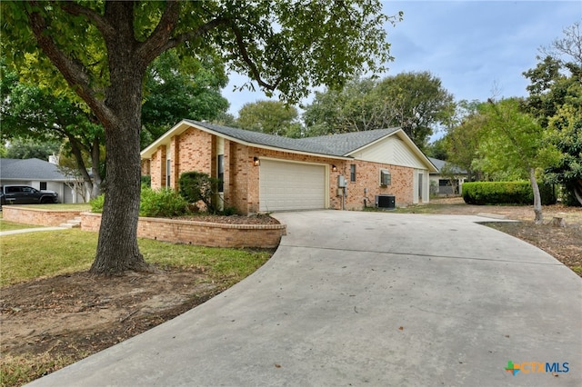 single story home with a garage and cooling unit