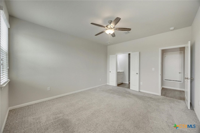 unfurnished bedroom featuring carpet, ceiling fan, and connected bathroom