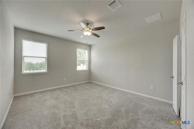 empty room featuring light carpet and ceiling fan