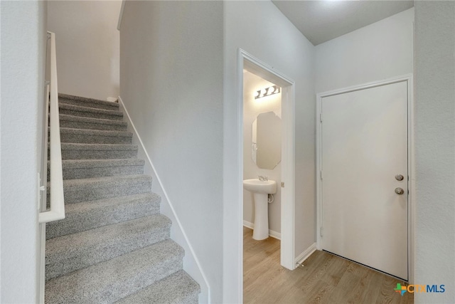 entryway with light wood-type flooring and sink