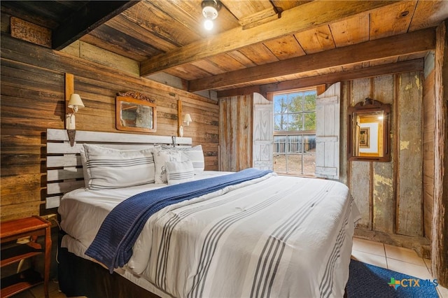 bedroom with beam ceiling, wooden walls, tile patterned flooring, and wood ceiling