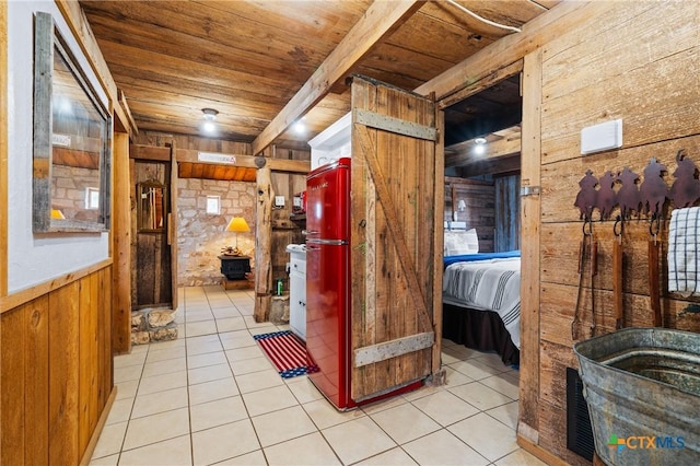 corridor with wood ceiling, wooden walls, and light tile patterned flooring