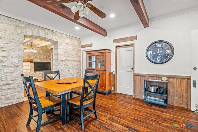 dining room with beamed ceiling, ceiling fan, and dark wood-type flooring