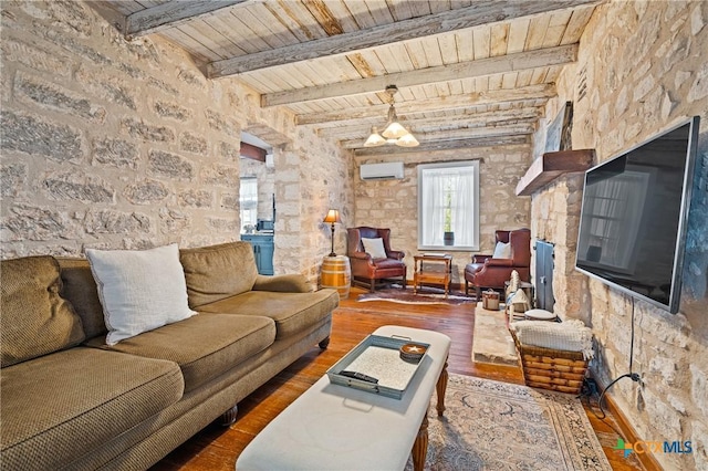 living room featuring beam ceiling, dark hardwood / wood-style flooring, wooden ceiling, and an AC wall unit