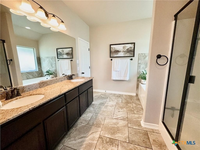 416 Coventry Dr, Temple, TX 76502 - bathroom featuring baseboards, a garden tub, double vanity, a shower stall, and stone finish flooring