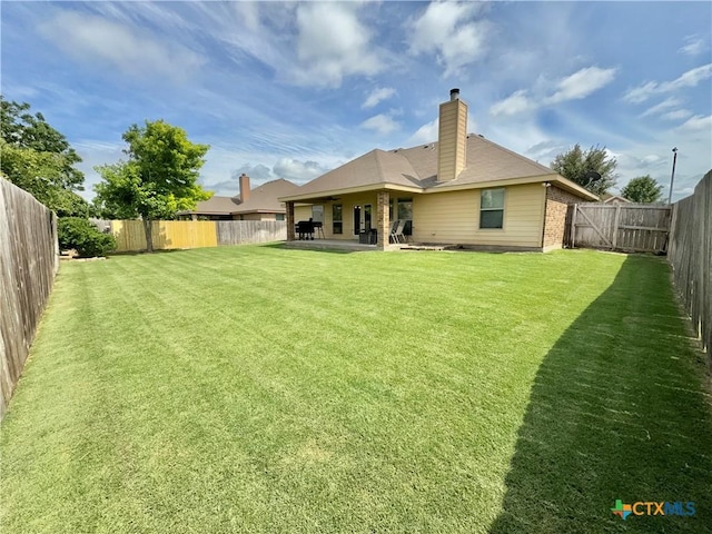 416 Coventry Dr, Temple, TX 76502 - rear view of property featuring a patio and a chimney