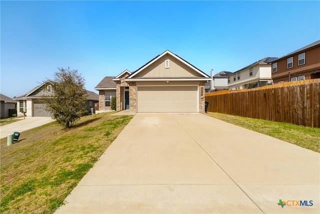 view of front of house featuring concrete driveway, an attached garage, fence, board and batten siding, and brick siding