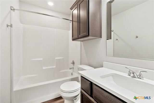 bathroom featuring washtub / shower combination, vanity, and toilet