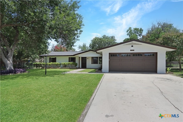 ranch-style home featuring a front lawn and a garage