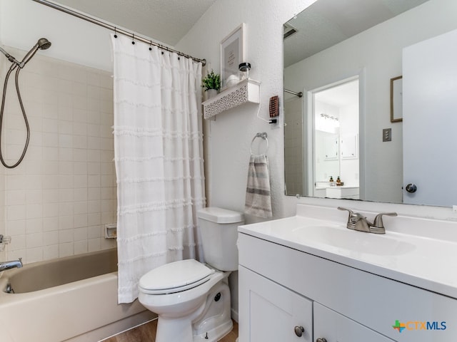 full bathroom featuring a textured ceiling, hardwood / wood-style floors, shower / tub combo with curtain, vanity, and toilet