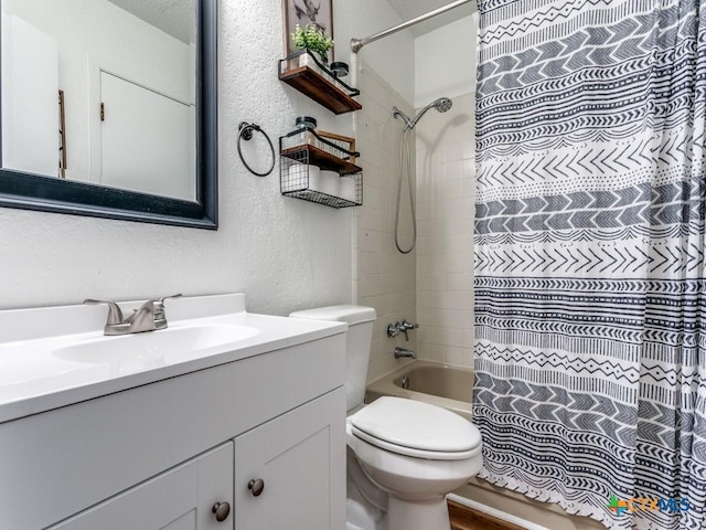 1133 Ashby St, Seguin, TX 78155 - full bathroom featuring a textured wall, vanity, toilet, and shower / bath combination with curtain