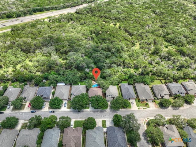aerial view of property and surrounding area featuring nearby suburban area