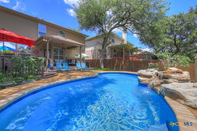 view of swimming pool with a fenced backyard and a patio