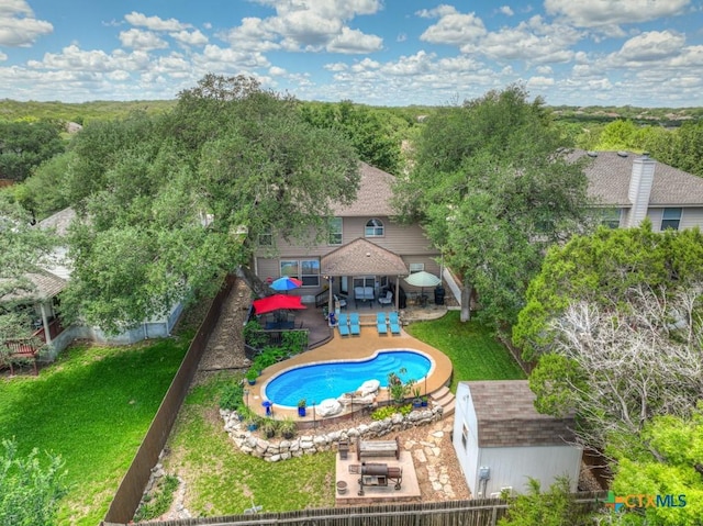 view of pool with a storage unit, an outdoor structure, and a patio