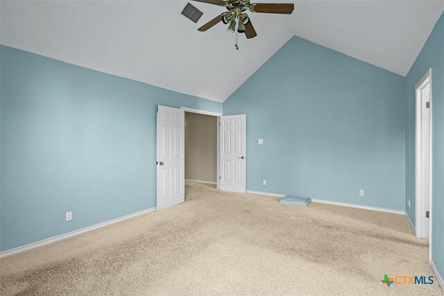 unfurnished bedroom featuring light colored carpet, high vaulted ceiling, and ceiling fan