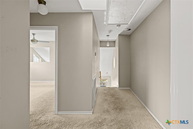 hallway with light colored carpet