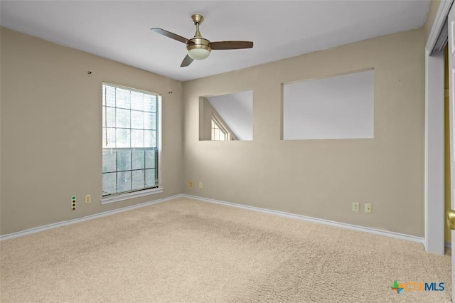 spare room featuring carpet flooring and ceiling fan