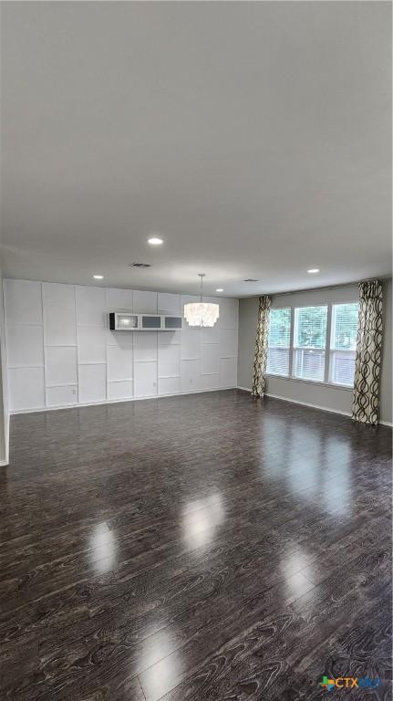 9012 Lonesome Oak Dr, Temple, TX 76502 - unfurnished room with a chandelier, dark wood-style floors, recessed lighting, and baseboards