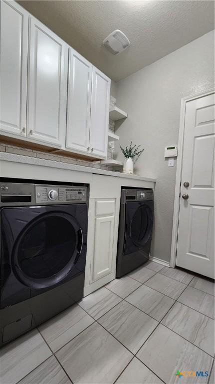 9012 Lonesome Oak Dr, Temple, TX 76502 - laundry area with washer / clothes dryer, cabinet space, a textured ceiling, and baseboards