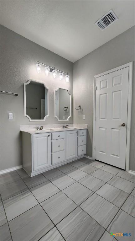 9012 Lonesome Oak Dr, Temple, TX 76502 - full bath with double vanity, baseboards, and tile patterned floors