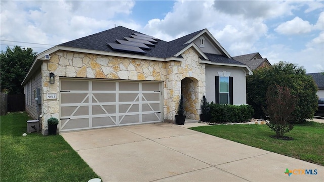 9012 Lonesome Oak Dr, Temple, TX 76502 - view of front of house featuring stone siding, solar panels, a garage, driveway, and roof with shingles