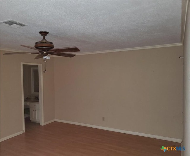 spare room with crown molding, hardwood / wood-style flooring, a textured ceiling, and ceiling fan