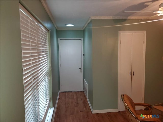 hallway with crown molding and wood-type flooring