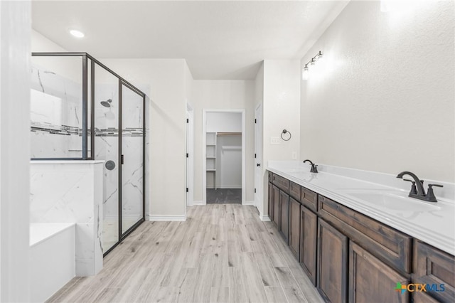 bathroom featuring vanity, hardwood / wood-style floors, and separate shower and tub