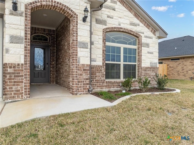 doorway to property featuring a lawn