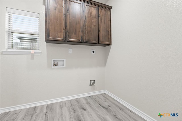 laundry area featuring cabinets, washer hookup, hookup for an electric dryer, and light wood-type flooring