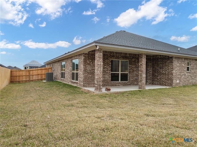 back of property featuring a patio, central AC, and a lawn