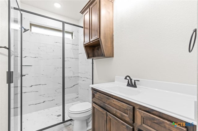 bathroom with vanity, an enclosed shower, and toilet