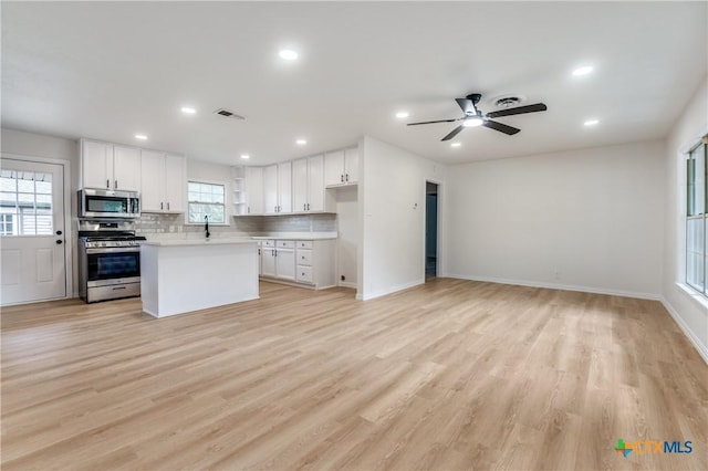 3524 Swan St, Fort Worth, TX 76117 - kitchen featuring appliances with stainless steel finishes, healthy amount of natural light, light countertops, white cabinetry, and recessed lighting