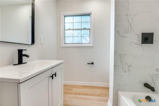 3524 Swan St, Fort Worth, TX 76117 - bathroom featuring vanity, wood finished floors, and bathtub / shower combination