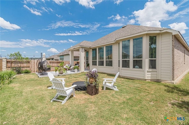 rear view of property with a patio and a lawn