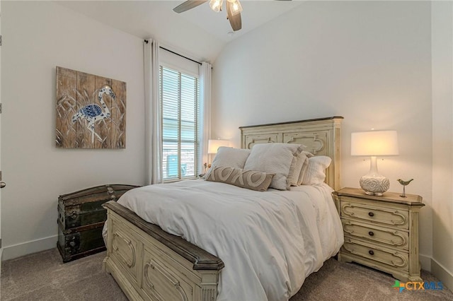 bedroom with vaulted ceiling, ceiling fan, and carpet flooring