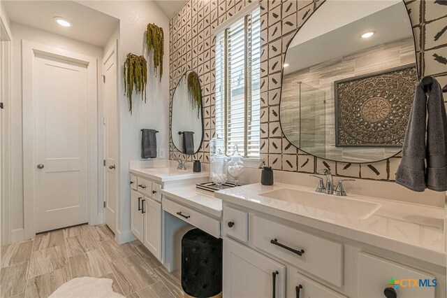 bathroom with vanity and a shower