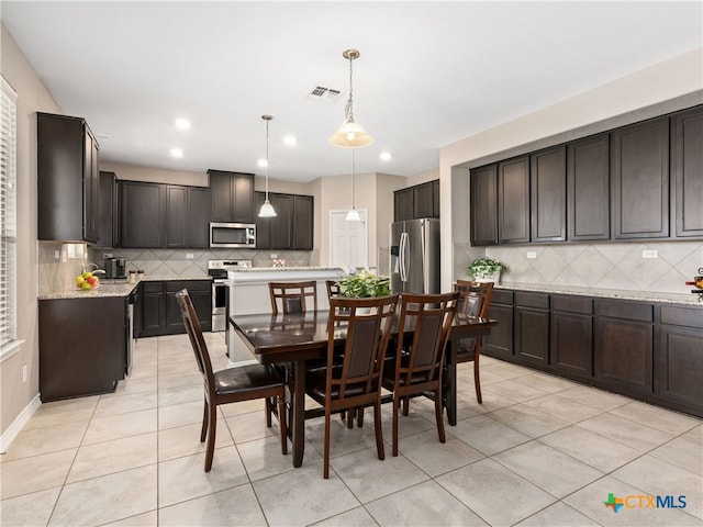 dining area featuring light tile patterned flooring