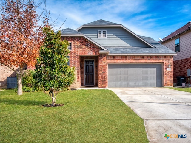 view of front of home featuring a garage and a front lawn