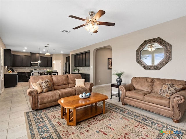 tiled living room with ceiling fan