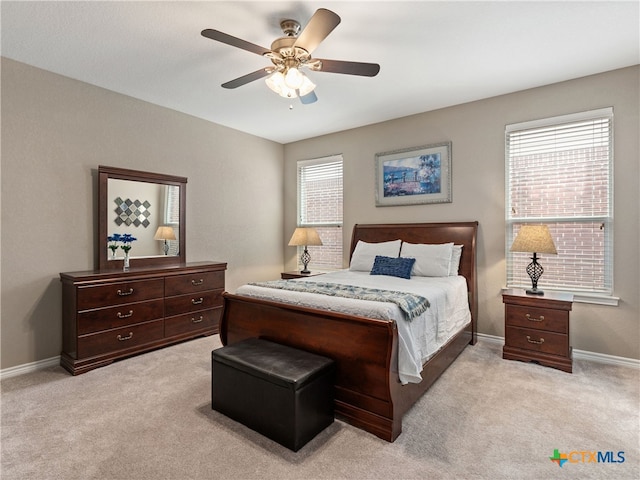 bedroom with ceiling fan and light carpet